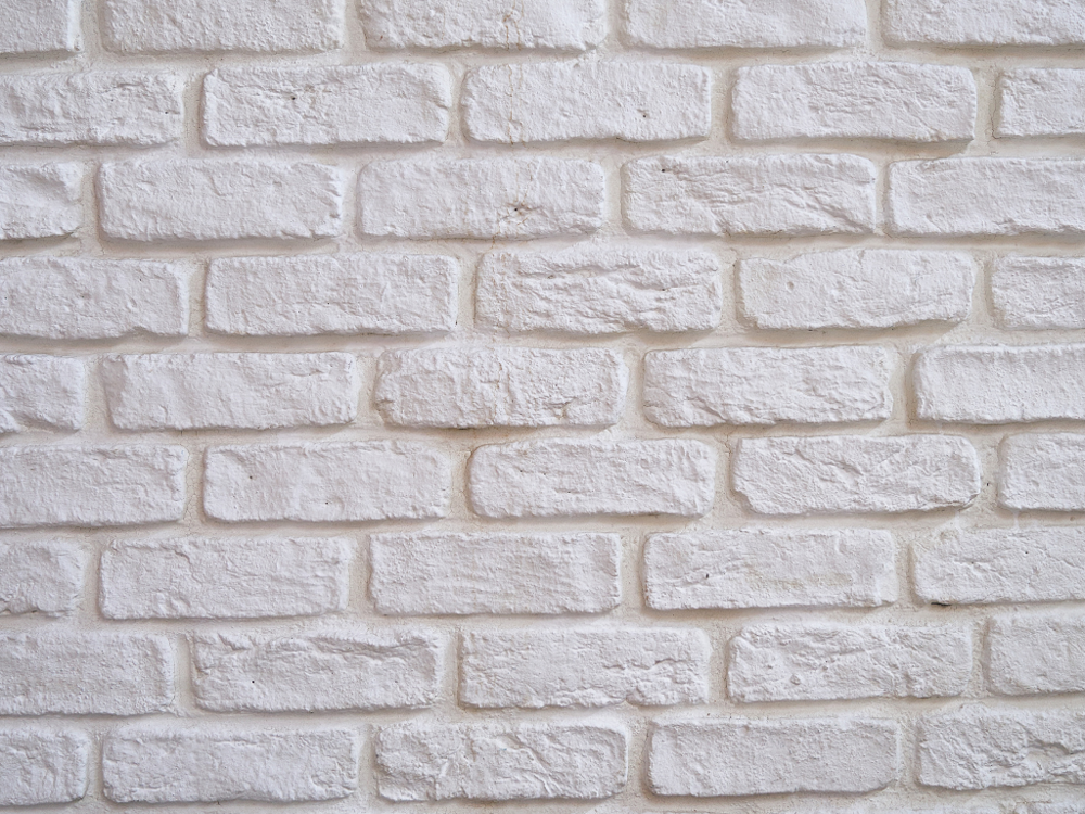 Masonry paint applied to brick wall